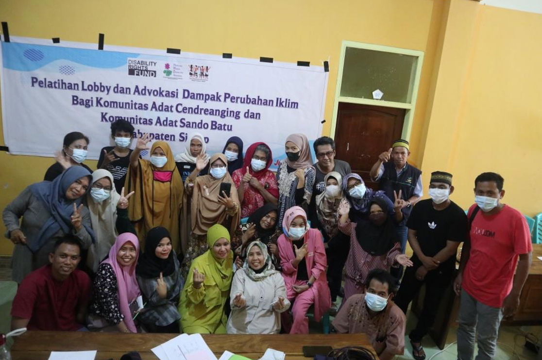 A group of people, many women, wearing masks pose for a photo.