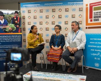 Cristina Coc (Maya Q’eqchi), Advocacy Coordinator at Indigenous Peoples Rights International (IPRI) moderating  panel "Criminaliza- tion of Indigenous  Peoples’ Rights" organized by IPRI in the Indigenous Media Zone at the UNPFII in April 2024, with Victoria Tauli-Corpuz (Kankanaey Igorot) and Fergus McKay.  Photo by Jamie Malcolm- Brown/Cultural Survival.