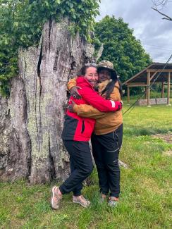 Jodi Newcomb and Chenae Bullock standing infant of the _Great Council Oak Tree_ photo taken by Reginald L. Bullock