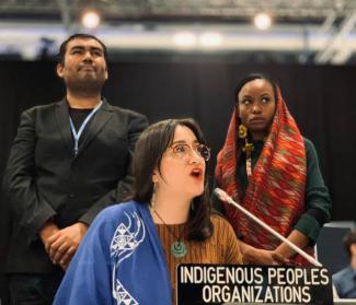  Kera Sherwood-O'Regan speaking into a microphone behind a podium